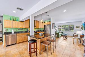 a kitchen with a table and chairs in a room at Casa Balsinde - Delight in a Private Pool in the Southern End of West Palm in West Palm Beach
