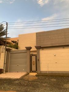a building with a garage door with a gate at بلو هيفن in As Sayl aş Şaghīr