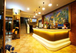 a lobby with a bar with a painting on the wall at i Boutique Hotel in Pluak Daeng