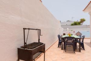 eine Terrasse mit einem Tisch, Stühlen und einem Grill in der Unterkunft Tranquil 4 Bedroom Holiday Villa in Callao Salvaje + 18 Fotos