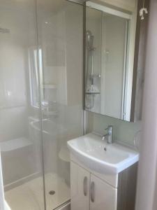 a white bathroom with a sink and a shower at Billing Aquadrome Holiday Park in Great Billing
