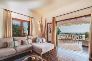 a living room with a couch and a patio at Villa Luciana - Radiante casa vecina del mar in Son Bou +30 photos