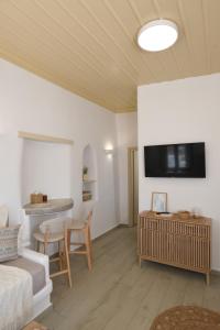 a living room with a couch and a table at Vento Apartment in Astypalaia Town +6 photos