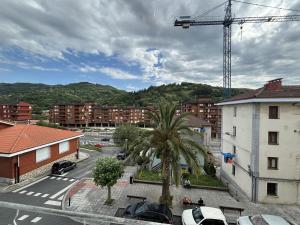 a city with cars parked in a parking lot at Ortuella Apartment in Ortuella