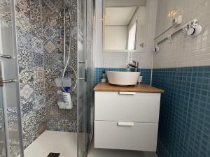 a bathroom with a sink and a shower at Ortuella Apartment in Ortuella +12 photos