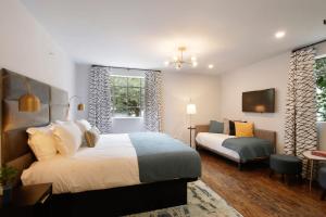 a hotel room with two beds and a window at King Suite and Twin Boutique Hotel 2 Floor in Savannah