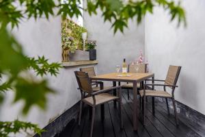 a table with chairs and a bottle of wine on a patio at Dingle Heritage Townhouse in Dingle