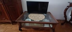 a wooden coffee table with a glass top on a table at Coroneo33 - Spazioso per famiglie - NaonBnB in Trieste +21 photos