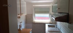 a small bathroom with a window and a sink at Cosy Apartment Geislingen in Geislingen an der Steige