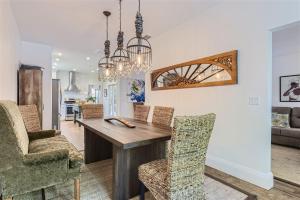 a dining room with a wooden table and chairs at Palm Beach Oasis - Indulge in Garden Tranquility with Alfresco Dining in West Palm Beach