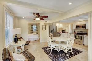a kitchen and dining room with a table and chairs at The Blue Pearl - Soak Up Views from a Scenic Poolside Upper Deck in West Palm Beach