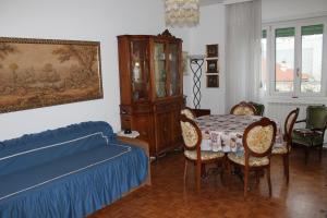 a bedroom with a bed and a table and chairs at Coroneo33 - Spazioso per famiglie - NaonBnB in Trieste