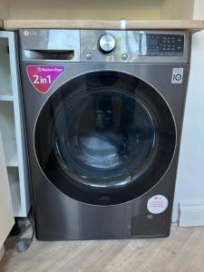 a washing machine is sitting on a floor at Victorian Town House in the Heart of Dover in Dover +3 photos