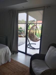 a bedroom with a door to a patio with a chair at Fonte da Arrigada in Cambre