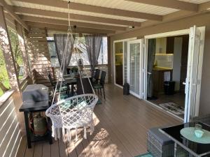 a screened in porch with a table and chairs at Solana in Drage +16 photos
