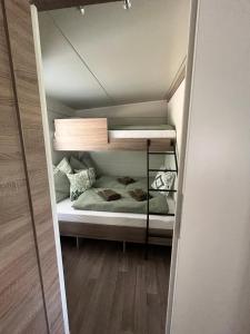 a small bedroom with a bunk bed in a room at Solana in Drage