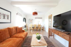 a living room with a couch and a table at Four bedroom detached family home near Elie in Kilconquhar