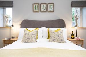 a bedroom with a large white bed with pillows at Hen Harrier Lodge in Lancaster