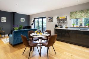 a kitchen and living room with a table and chairs at Hen Harrier Lodge in Lancaster