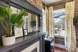 a living room with a fireplace and a window at Sunny Queen Suite Downtown 2nd Floor in Savannah