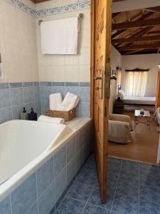 a bathroom with a bath tub and a room at Traditional House in Pámfylla +27 photos