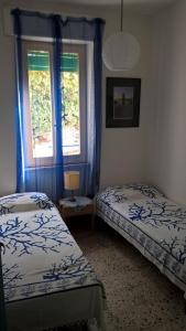 En eller flere senge i et værelse på Casa Lido zia Frankie