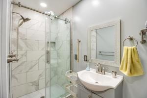 a bathroom with a sink and a shower at 13 Mi to Guntersville Lake Henagar Gem with Hot Tub in Pisgah +20 photos