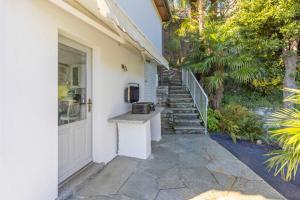 a house with a door and a counter next to a staircase at Casa Samara in Cannobio +11 photos