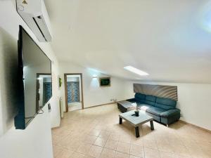 a living room with a couch and a table at Sealovers house with sea view & big terrace in Civitavecchia