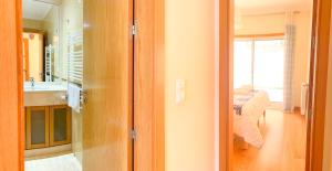 a room with a bathroom with a sink and a mirror at Villa Terraços do Castelo by DolceStay in Sesimbra +71 photos