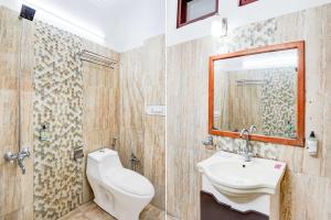 a bathroom with a sink and a toilet and a mirror at Collection O Mall Road Library Chowk in Mussoorie