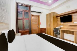 a hotel room with a bed and a desk at Collection O Sector 4 Gurgaon in Gurgaon