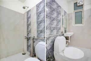 a bathroom with a toilet and a shower at Collection O Sector 4 Gurgaon in Gurgaon