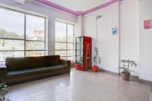 a living room with a couch and a tv at Collection O Sector 4 Gurgaon in Gurgaon