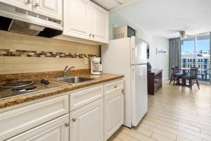 Una cocina con fregadero y refrigerador blanco. en 6201 Ocean Ave, Unit 304 - The Nassau Inn, en Wildwood