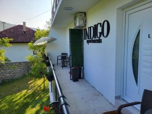 a patio with a sign on the side of a house at Apartments Indigo in Jajce