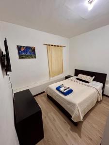 a bedroom with a bed and a tv in it at Hotel Santa Marta Centro Histórico in Popayan +67 photos