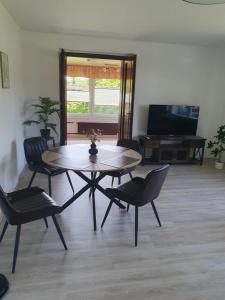 a living room with a table and chairs and a television at Ferienwohnung in Rechlin