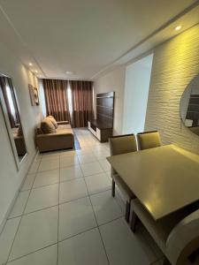 a living room with a couch and a table at Apartamento Caruaru in Caruaru