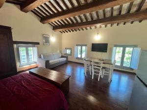 a living room with a bed and a table and chairs at Casale San Francesco d'Assisi in Assisi