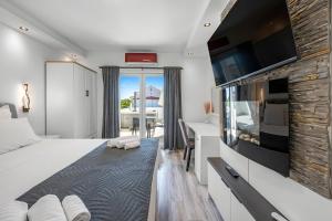a bedroom with a bed and a flat screen tv at Apartments 1 with pool and private jacuzzi in Vodice