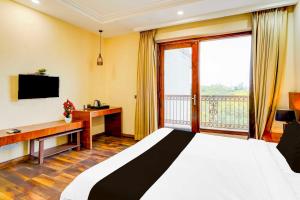 a hotel room with a bed and a balcony at Townhouse Oak Sector 47 Near Medanta in Gurgaon