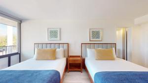 two beds in a room with a window at Park Royal Orlando in Kissimmee +44 photos