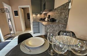 a dining room table with wine glasses on it at Budas in Plieņciems +34 photos