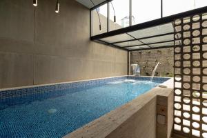 a large swimming pool in a building with a pool at Unique Luxury Loft 715 in Bogotá