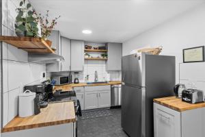 a kitchen with white cabinets and a stainless steel refrigerator at Relaxed 1BR Mountain Escape w Fireplace & Parking in Steamboat Springs