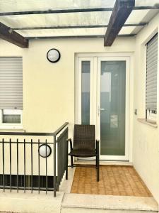a chair sitting on the front porch of a house at Appartamento Damma's in Cesenatico