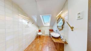a bathroom with a sink and a mirror at Marktplatz Traunsee LAKE View in Gmunden +17 photos