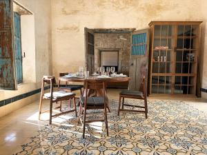 una sala da pranzo con tavolo e sedie in legno di Aurora by Awakening - Luxury house near the sea a El Cuyo Altre 15 foto