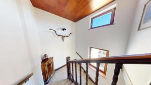 a staircase with white walls and a wooden ceiling at Marktplatz Traunsee LAKE View in Gmunden